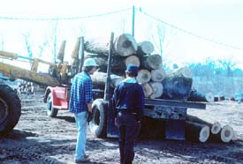 A powered industrial truck pushes the load off the truck.