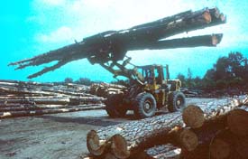 Tractor carrying logs through yard in unstable manner
